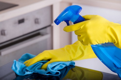 Cleaning staff maintaining desks and shared office surfaces
