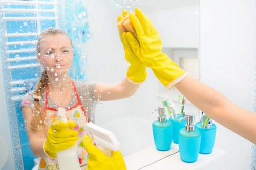 Domestic cleaner tidying a Richmond upon Thames family home